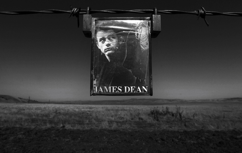 A small photo of James Dean hangs on a barbwire fence close to where his car landed after his car accident on September 30th, 1955. Dean died of a broken neck after colliding with Cal Poly student, Donald Turnupspeed at the Highway 46 and Highway 41 junction. Photo by Matt McClain