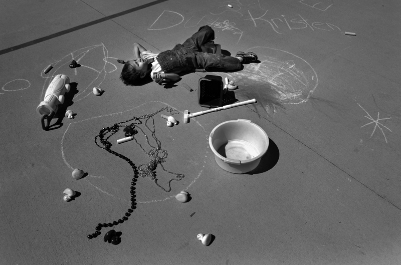Pandu Fayre, 6, lays on a basketball court as he plays by himself at a Family Learning Retreat at the Colorado School for the Deaf and the Blind in Colorado Springs, Colo. Sunday 06/07/09. Photo by Matt McClain