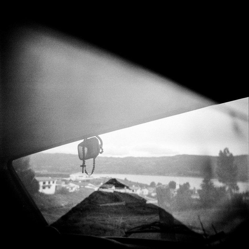 Colombia: a mass grave A rosary hangs from the rearview mirror of a car in Guatavita, a small town 70 kilometers from the capital Bogota. Most Colombians are extremely religious and often their religion leads them to accept with resignation and surrender their fate of misery and death. Guatavita, December 2012.