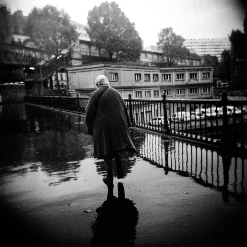 Urban Labyrinths Old woman faces a rainy day in Paris. Paris, November 2013.