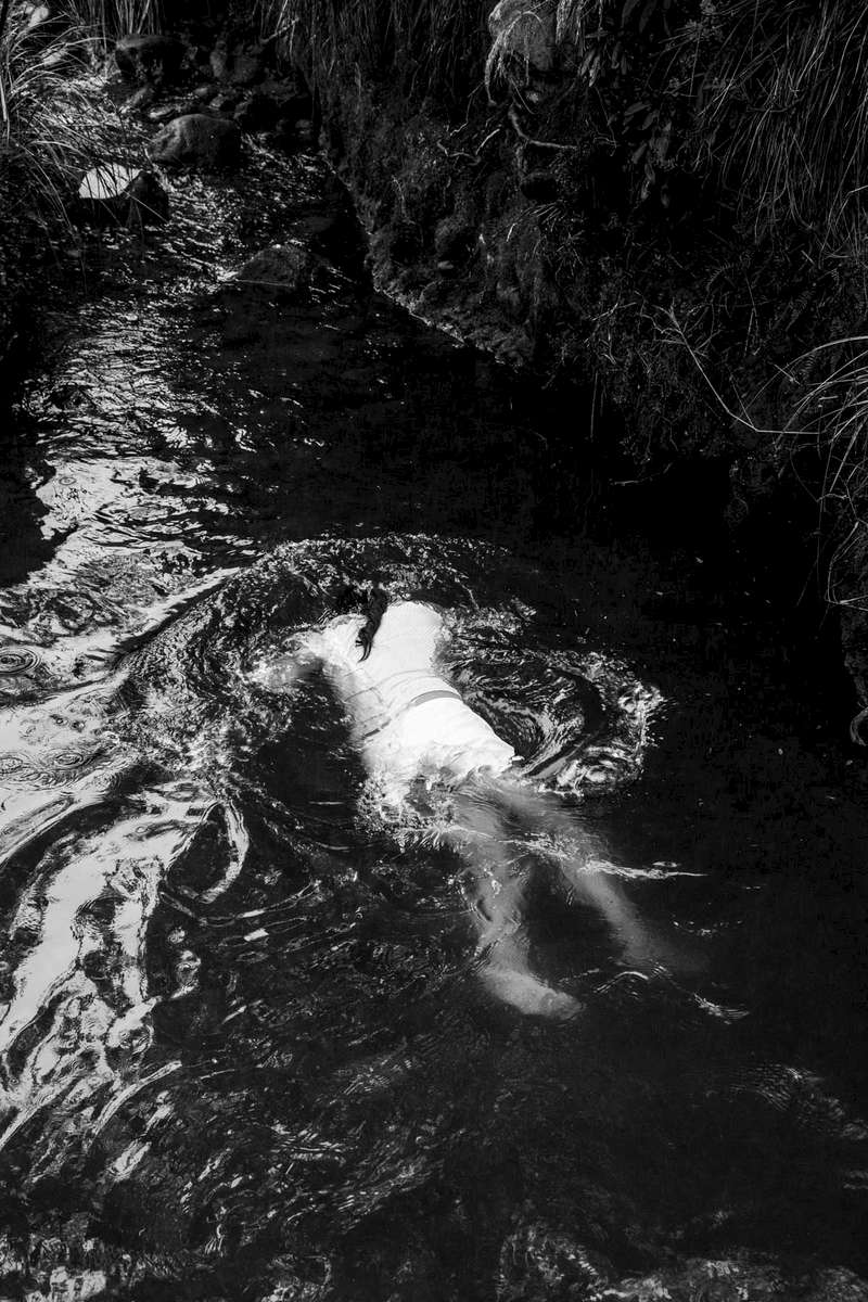 Indigenous Legacy Woman from the Nasa indigenous community washes herself in the icy waters of the Páramo de Pisnos as part of the cleansing ritual of the 'Khabu fxizehnxi' ('Refreshing of the Batons”), one of the five main rituals of the Nasa indigenous people of the Cauca region in Colombia. Cauca region, Colombia, January 2019.
