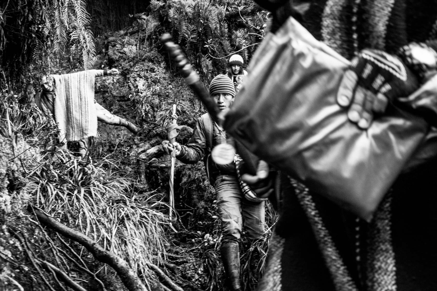 Indigenous Legacy People from the Nasa indigenous community climb a sacred mountain in the Páramo de Pisnos to make an offer as part of the cleansing ritual of the 'Khabu fxizehnxi' ('Refreshing of the Batons”), one of the five main rituals of the Nasa indigenous people of the Cauca region in Colombia. Cauca region, Colombia, January 2019.