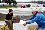 Justin Rice, left, a prep cook at Brandy’s restaurant, and Eric Jacobsen, chef at Brandy’s, load a deep fryer onto a U-Haul for safekeeping as floodwaters rose in Peru, Ill. Brandy’s and Waterstreet Pub took precautions as the Illinois River rose, each restaurant emptying as much as possible before the river crested.