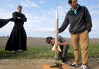 Brother Luke McLachlan, O.S.B., watches as high schoolers Killian and Marcus Cirone, members of the St. Bede science club’s rocket team, prepare to launch a rocket that would soar 752 feet into the air outside Peru, Ill. 
