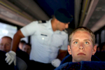 A basic cadet listens to a cadre member in the background during the Air Force Academy intake day in Colorado Springs, Colo. As soon as the bus pulled out of sight of parents, the grilling began for aspiring cadets. 