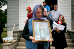 Madeline Pisani, of St. Louis, carries a St. Ioasaph (Joseph) of Belgorod portrait during a celebration for the 100th anniversary of the saint’s glorification at St. Ioasaph’s Russian Orthodox Church in Muddy, Ill. Pisani said her family donated the land that the church — which was built 98 years ago and paid for by Tsar Nicholas II — stands on and they continue to care for it now. 