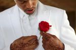 Michael Connley makes sure his boutonnierre is properly attached before his wedding to Kavita Desai in Marion, Ill. 