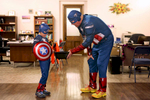 Attorney Scott Ealy, dressed as Captain America, offers candy to miniature Captain America Justin Brummer, 8, during the Effingham Downtown Safe Trick-or-Treating in Effingham, Ill. 